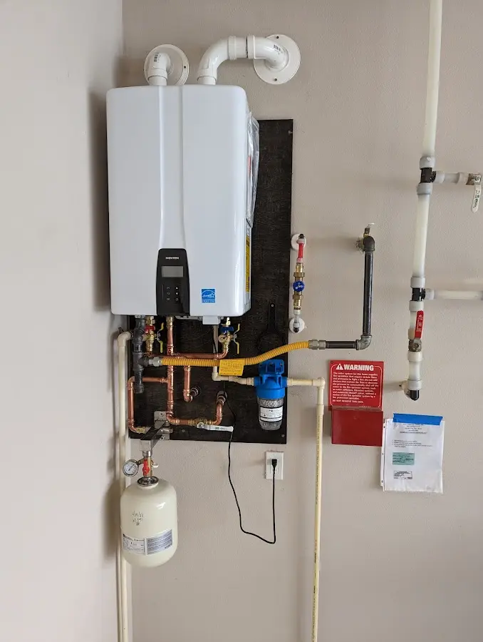 Professional plumber installing copper piping in a Pine Ridge home